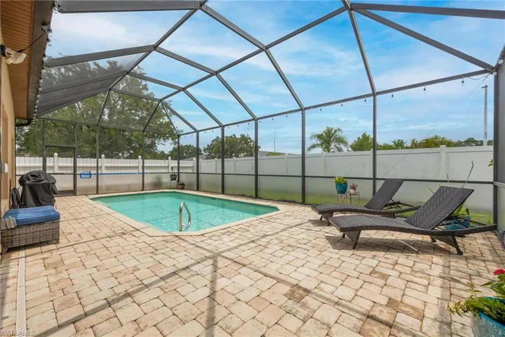 Pavestone deck surrounds this in-ground salt water pool. Full fenced yard for nice privacy.