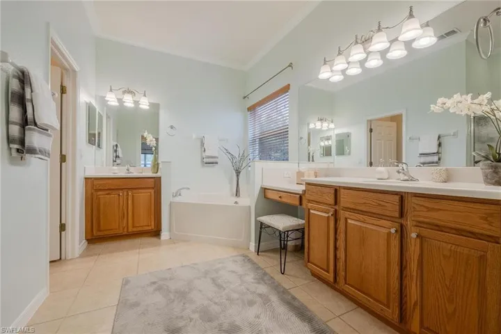 Primary Bath with dual sink/vanities, separate soaking tub, private toilet room and walk-in shower. This is a large bathroom with lots of storage and a linen closet.