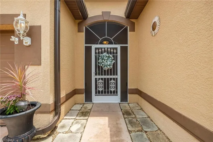 View of property entrance, with screened and covered front entrance.