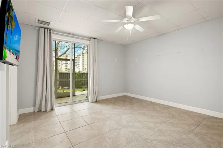 3rd  bedroom with ceiling fan and light tile patterned flooring