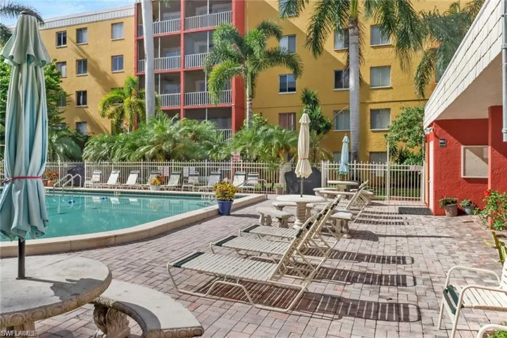 Pool with a patio and fence
