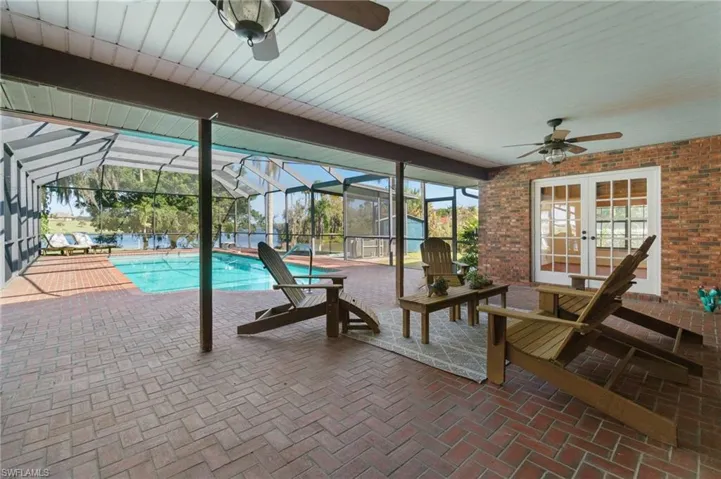 View of patio with ceiling fan and french doors