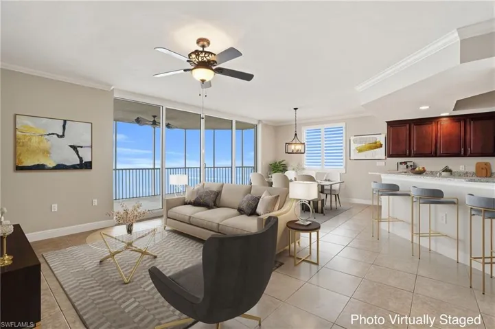 Virtually Stagged Living/Dining area room featuring floor to ceiling windows, ornamental molding, ceiling fan, and light tile floors