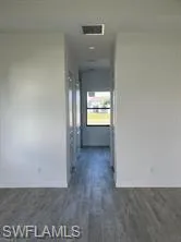 Hall with dark wood finished floors
