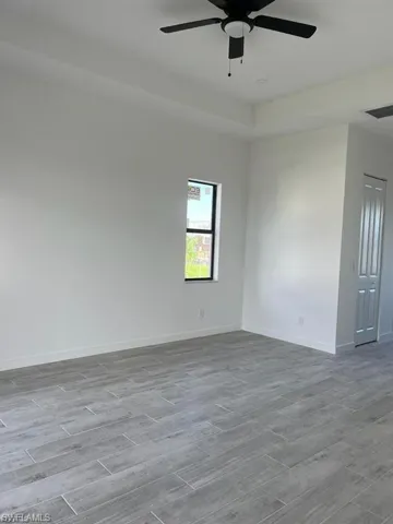 Empty room featuring wood finish floors and a ceiling fan