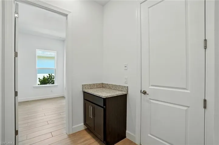 Bathroom with light wood-style floors and vanity