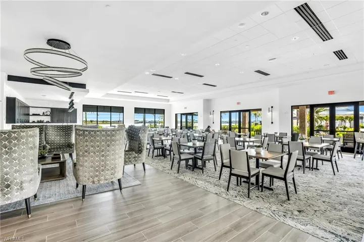 Dining space with plenty of natural light, wood tiled floors, and recessed lighting