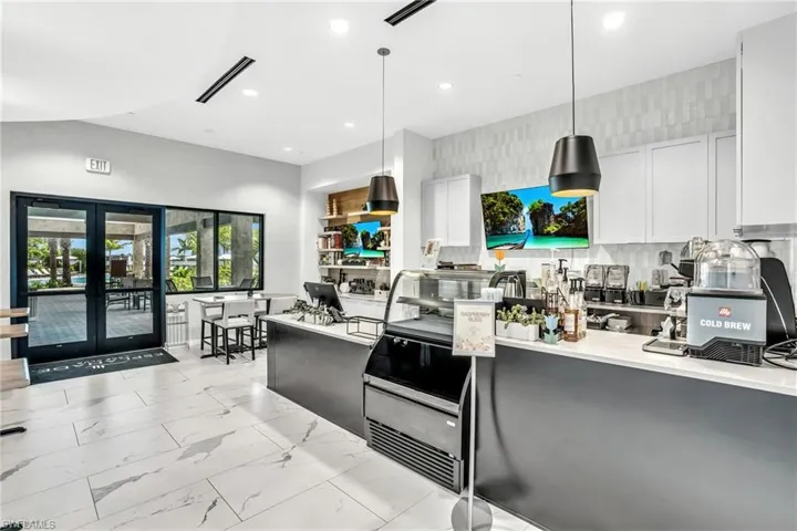 Kitchen featuring tasteful backsplash, french doors, light marble finish flooring, recessed lighting, and decorative light fixtures