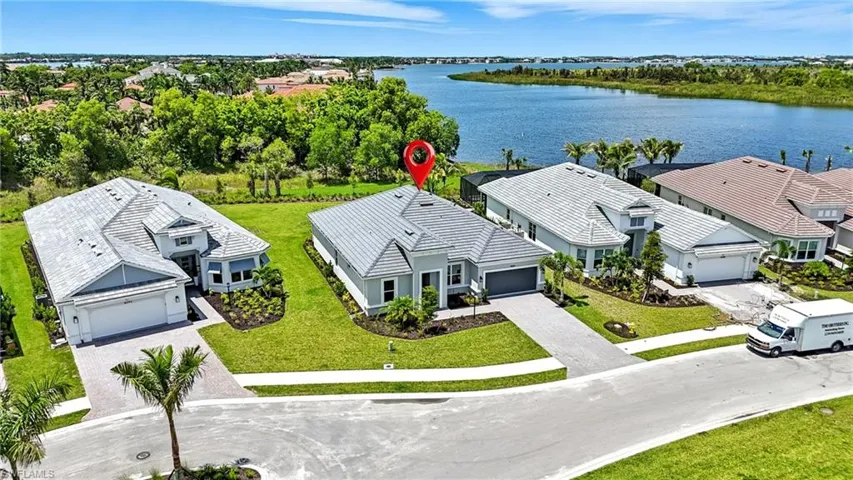 Aerial view of residential area featuring a large body of water