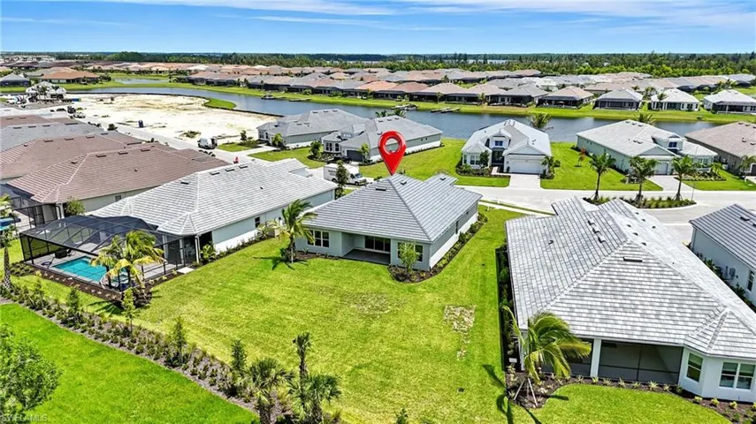 Aerial perspective of suburban area featuring a large body of water