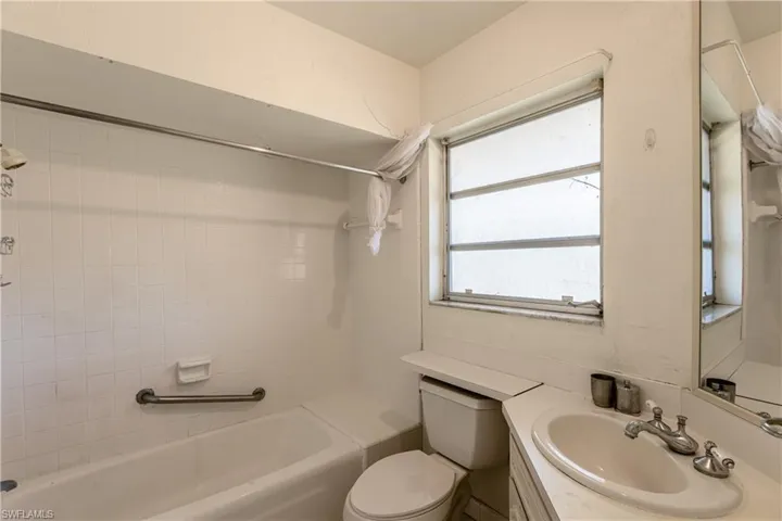 Full bathroom with bathtub / shower combination, vanity, and toilet