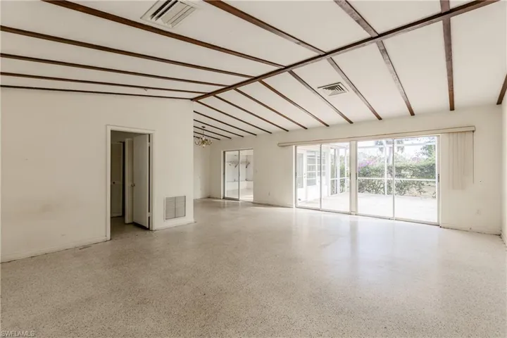 Spare room featuring vaulted ceiling