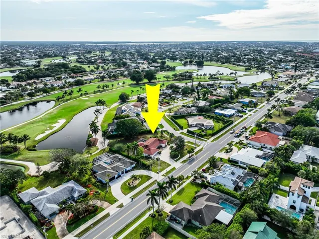 Birds eye view of property with a water view