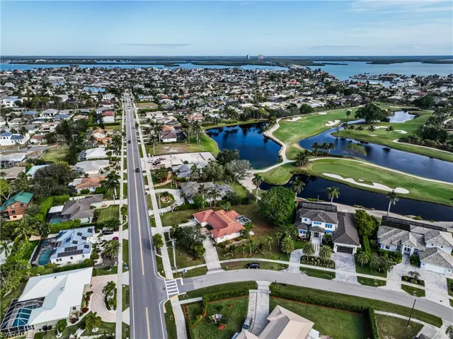 Birds eye view of property with a water view