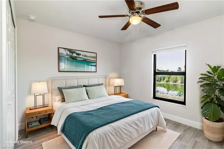 Bedroom with ceiling fan and light hardwood / wood-style floors