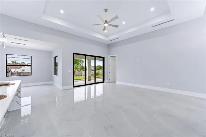 Spare room featuring a tray ceiling and ceiling fan