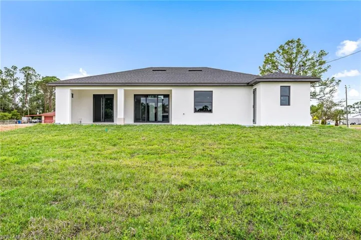Rear view of property featuring a yard