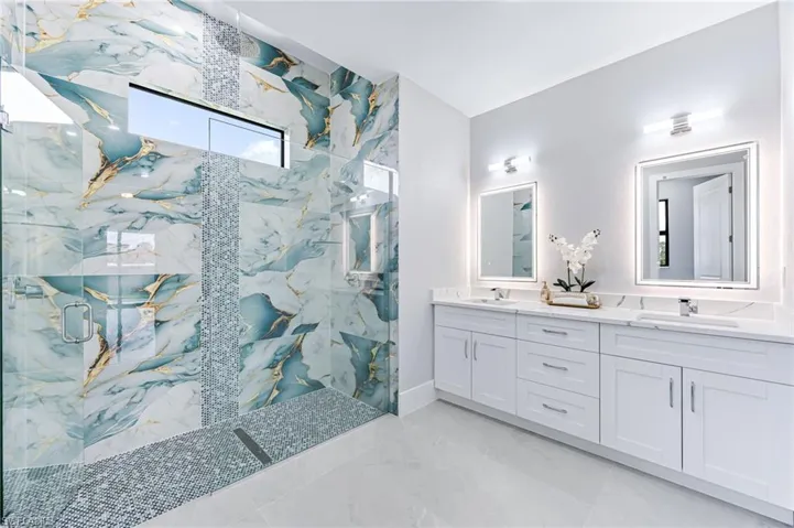 Bathroom featuring vanity and a shower with shower door