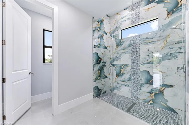 Bathroom featuring a shower with door