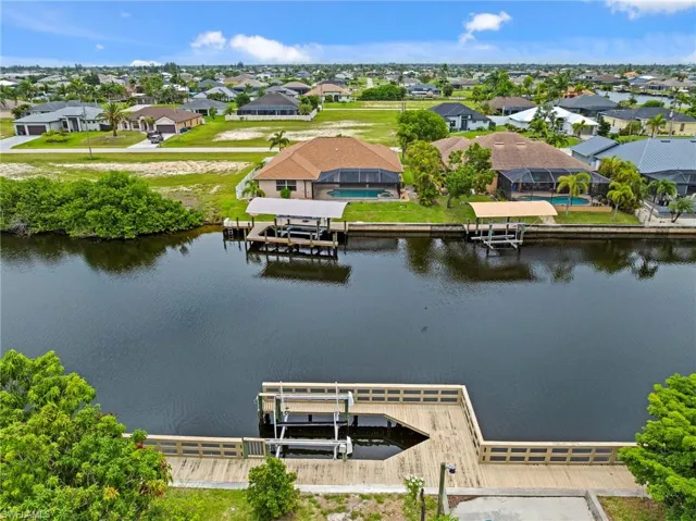 Aerial perspective of suburban area featuring a large body of water