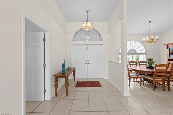 Entrance foyer featuring a chandelier and light tile patterned flooring