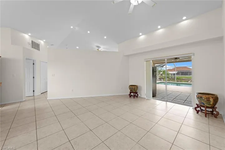 Unfurnished room with ceiling fan, high vaulted ceiling, light tile patterned floors, and recessed lighting