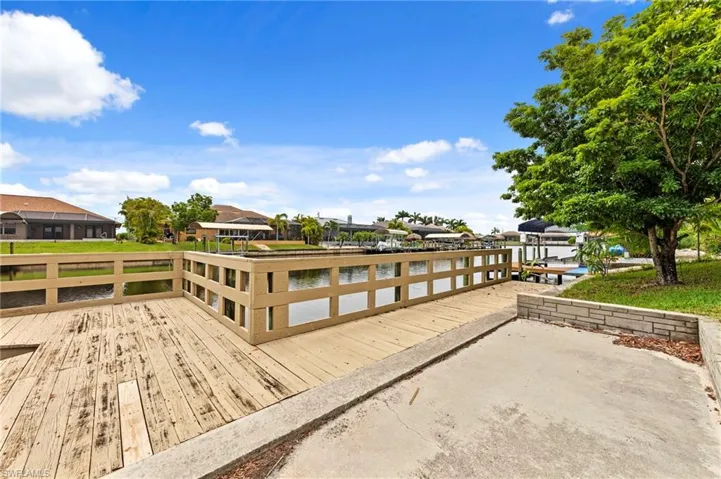 Dock area with a residential view and a deck with water view