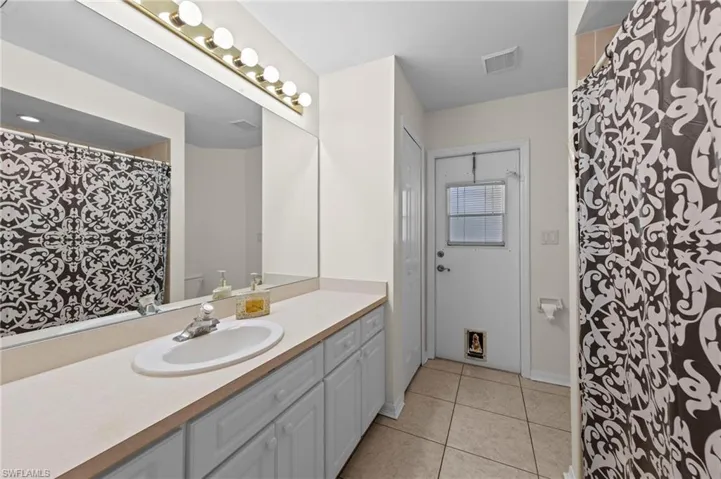 Full bathroom featuring vanity and tile patterned flooring
