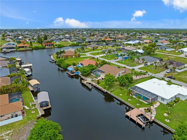 Aerial perspective of suburban area featuring a nearby body of water