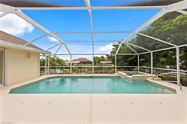 View of pool with a patio area, a pool with connected hot tub, and a lanai