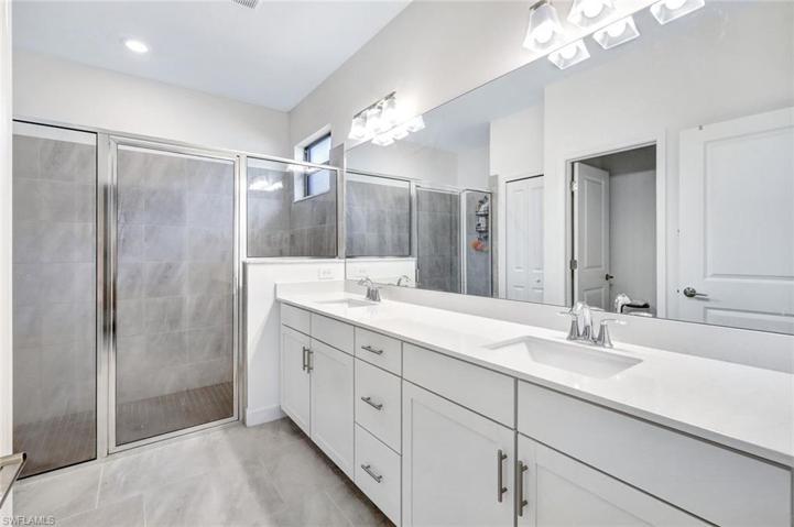 En suite primary bath with dual sinks.