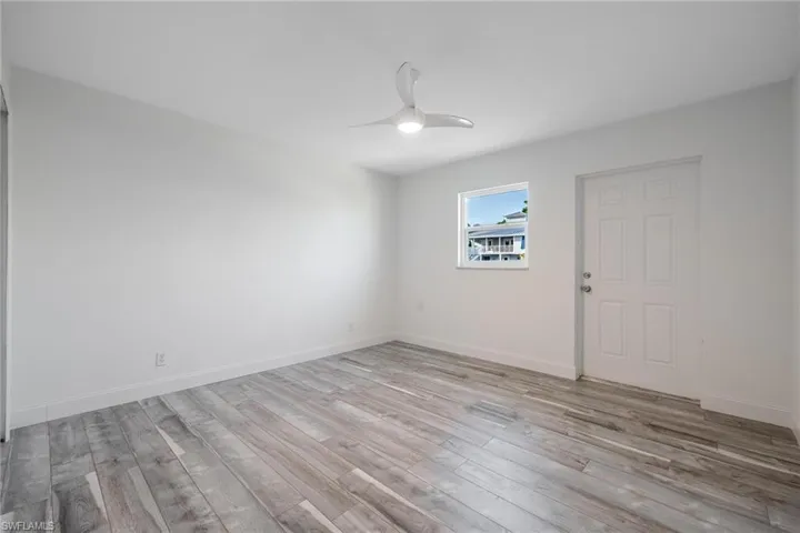 Bedroom featuring ceiling fan and light hardwood / wood-style laminate flooring
