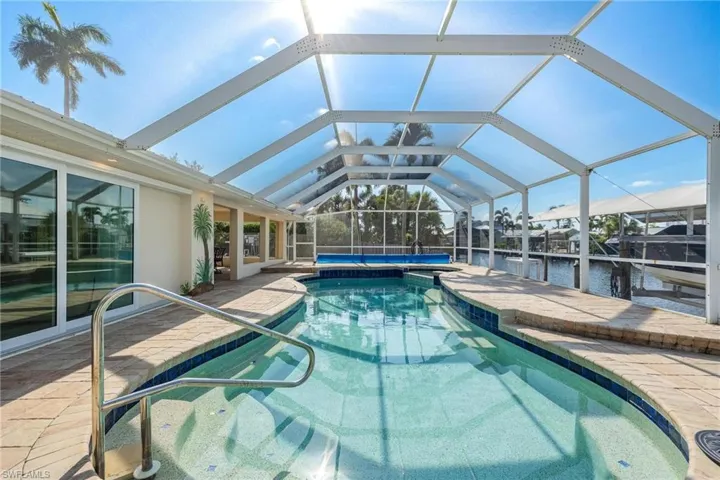 View of swimming pool with a patio and a lanai