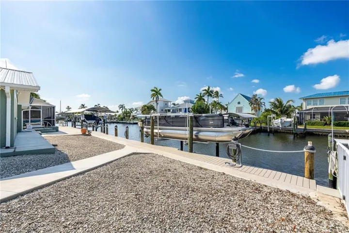 Dock area with a lanai and a water view
