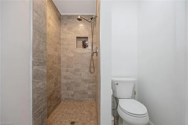 Bathroom with tiled shower and toilet