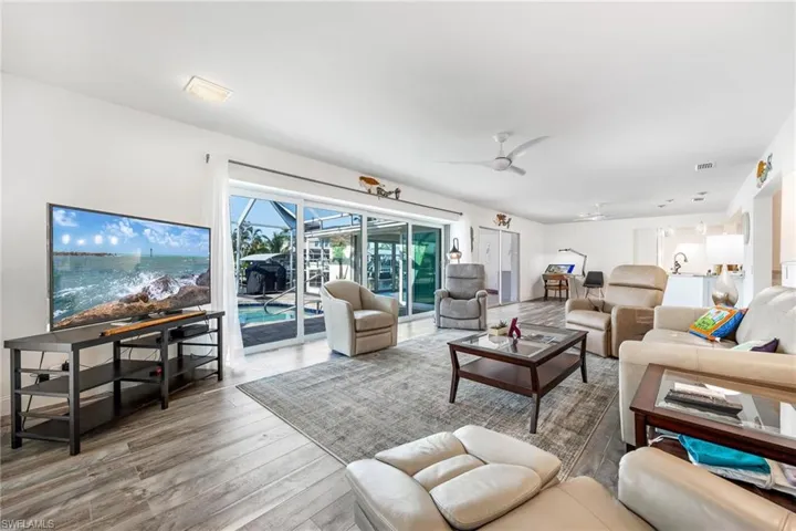 Living room featuring ceiling fan and hardwood / wood-style flooring