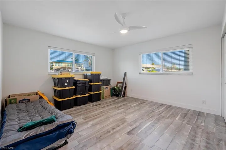 Bedroom featuring ceiling fan and light wood-type flooring