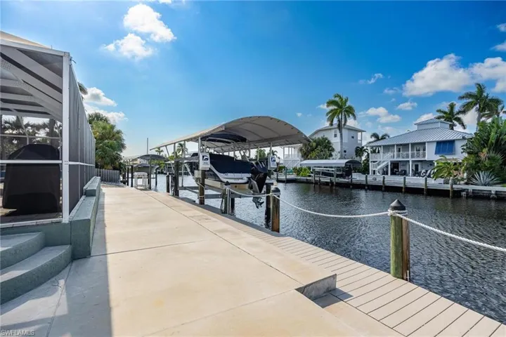 View of dock with glass enclosure and a water view