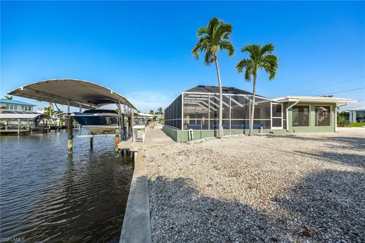 Dock area with glass enclosure and a water view