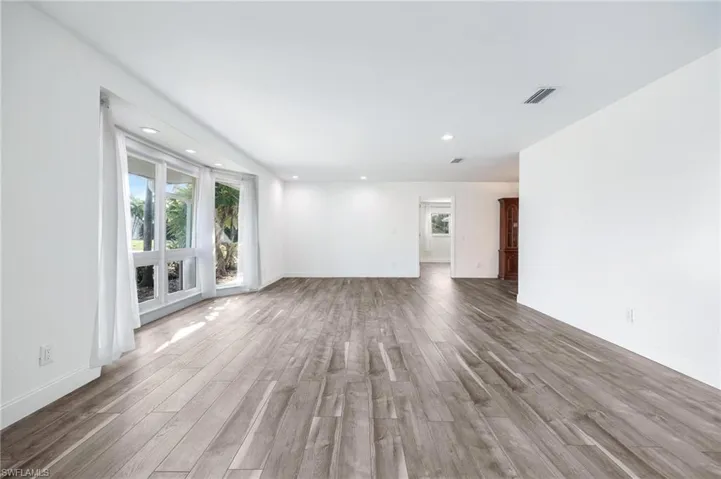 Unfurnished living room featuring hardwood / wood-style flooring