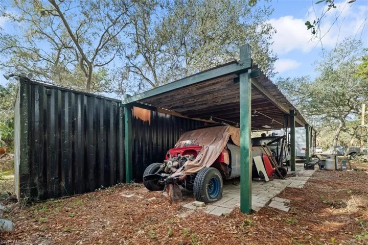 View of parking with a detached carport