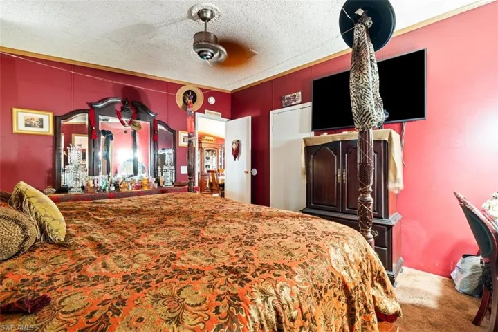 Carpeted bedroom featuring a textured ceiling