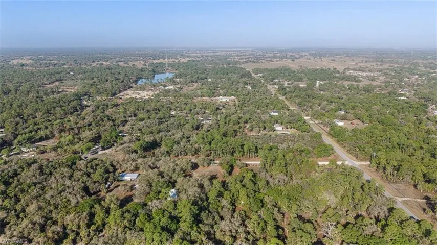 Aerial view of a heavily wooded area and a large body of water