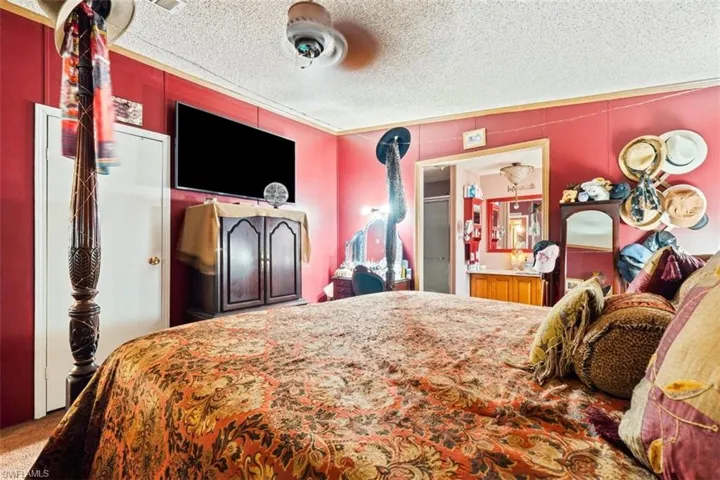 Carpeted bedroom featuring a textured ceiling