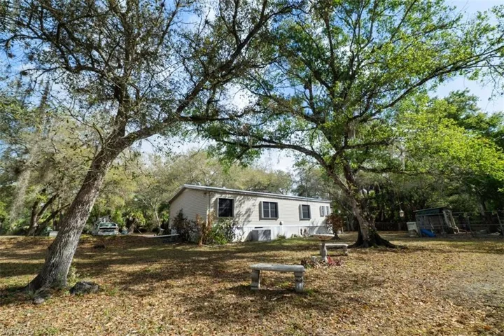 View of front of home with view of wooded area
