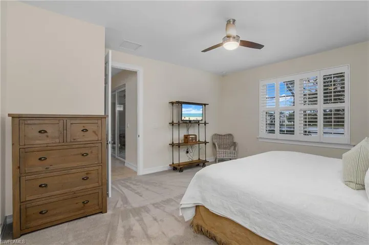 Spacious master bedroom with ceiling fan