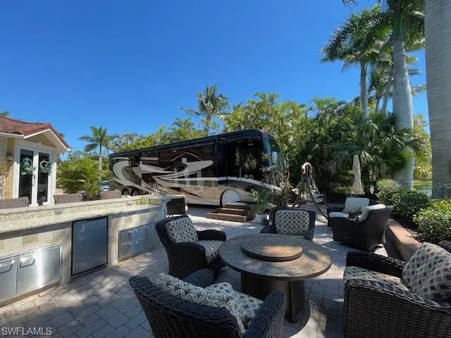 View of patio featuring an outdoor kitchen and an outdoor fire pit