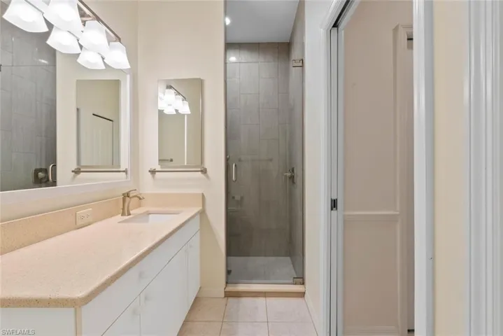 Full bathroom with vanity, recessed lighting, a stall shower, baseboards, and tile patterned floors