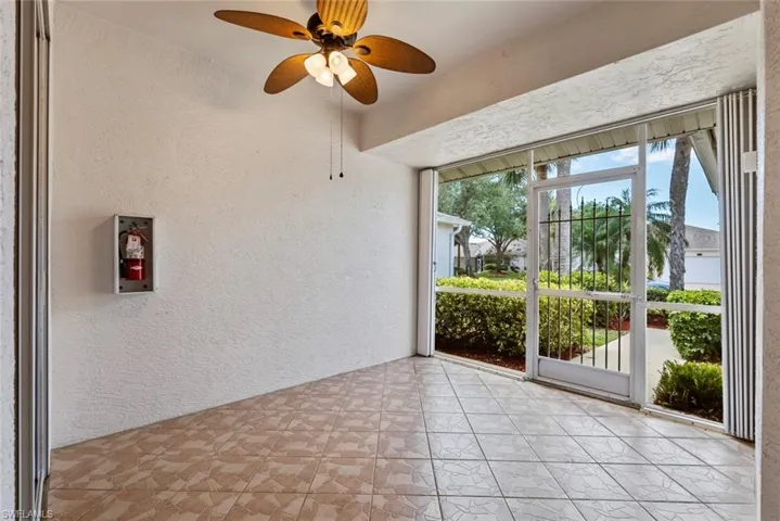 View of screened in front lanai with hurricane shutters and garage door entry