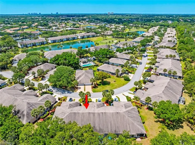 Birds eye view of property featuring a water view and a residential view